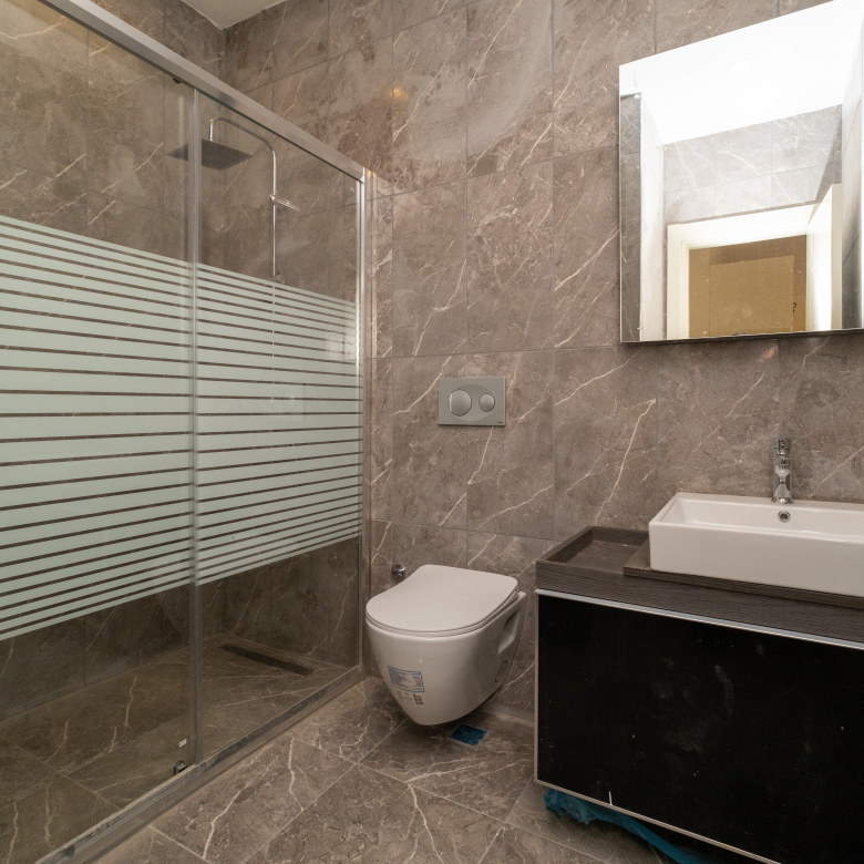 Elegant bathroom in Taksim Palas featuring marble finishes, a spacious shower area, and premium fixtures.