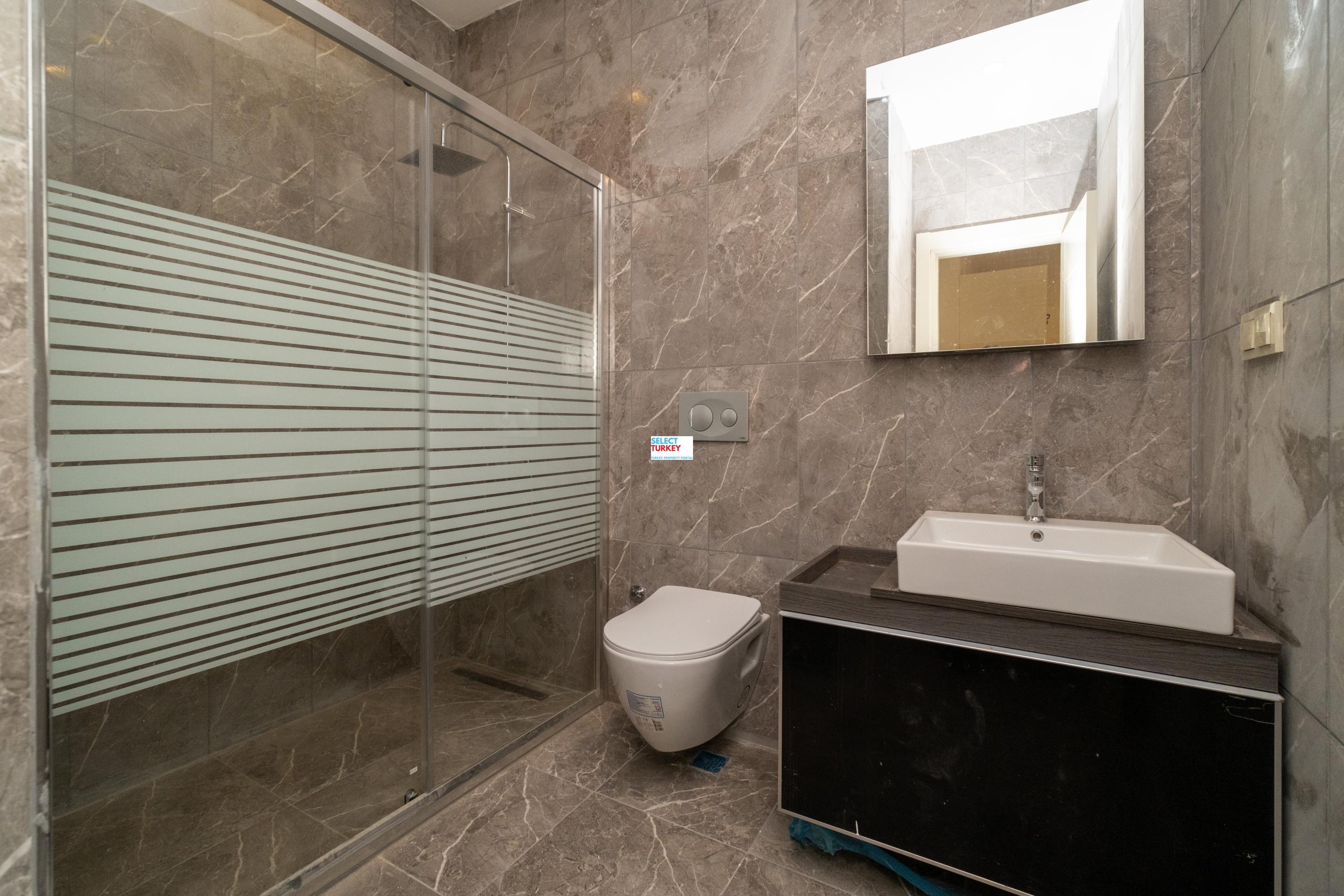 Elegant bathroom in Taksim Palas featuring marble finishes, a spacious shower area, and premium fixtures.