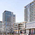Modern high-rise residential buildings of Akzirve Strada Bahçeşehir with landscaped green areas.